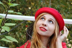 pretty Woman In Red hat looking up