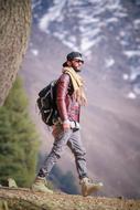 young man with a beard on a hike on a sunny day