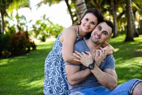 adult Couple In Love on lawn at sunny day