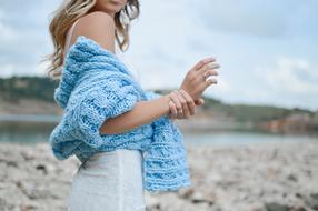 blue knitted clothe on body of girl outdoor