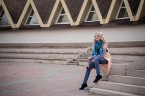 Girl in pink sitting on the stairs