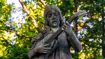 stone sculpture of a girl with a guitar