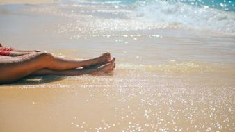 female and male legs on Beach