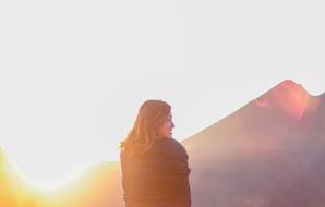 Young Girl in front of mountains at sunrise