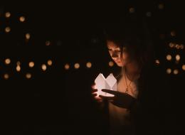 young girl with candle at darkness, Bokeh background