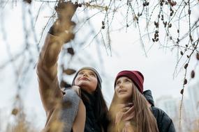 mother and teen Daughter looking at bare tree branches