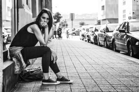 posing young woman on the sidewalk