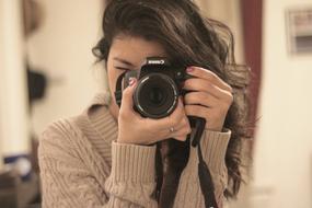 Photographer, young girl with camera at eye