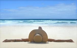 woman lying on the white sand