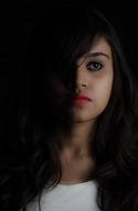 Sad young girl, low key portrait
