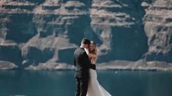 dance of the bride and groom on the background of the rock