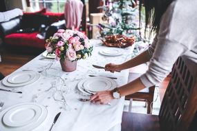 girl setting the table for christmas