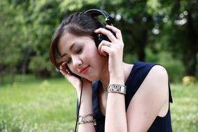 Beautiful asian girl listening music outdoor