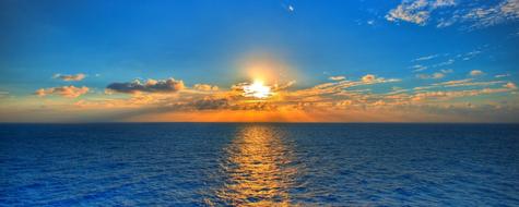 tranquil golden sunset above blue sea