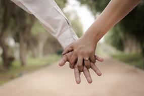 couple hands with rings