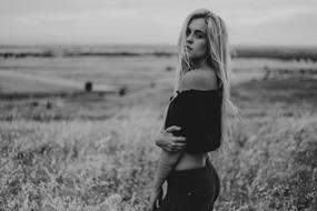 black and white picture of a beautiful woman on the field