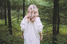 back view of Blonde woman in Forest
