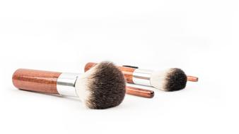 fluffy makeup brushes on a white background