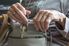 keys in the hands of an old woman