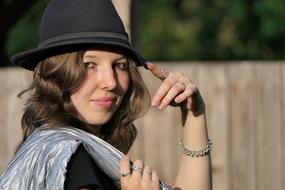 Portrait of attractive Young Woman in black fedora Close Up