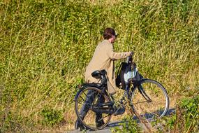 woman pushing her bike