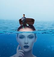 girl underwater has a sofa with a man on her head