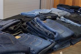 stacks of jeans in second hand