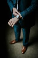 wristwatch on hand of man in formal suit