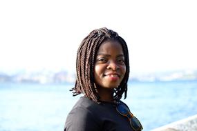 young happy african american woman on blur nature background