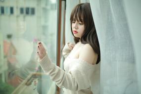 young asian woman near the window