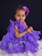 Cute dark skin Child Girl in fluffy purple dress