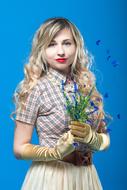 nice girl in Plaid Shirt and long Gloves holds flowers