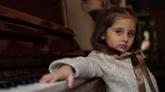 little girl by the piano