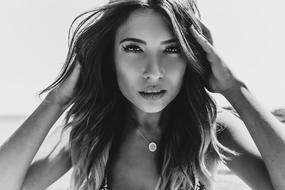 Black and white portrait of the beautiful woman on the beach