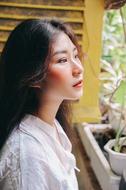 portrait of a young asian girl near the window