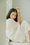photo of asian girl in white suit without makeup