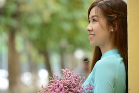 photo of an asian girl with a bouquet of purple flowers