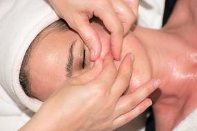 skin care, female hands cleaning face of woman