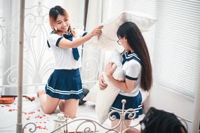 girls play with pillows
