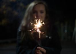 Celebration, sparklers in front of blur girl