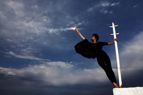 slim woman with torch at sky