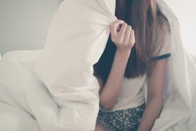 young girl wrapped up in blanket