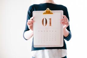 calendar with New Year Date in female hands