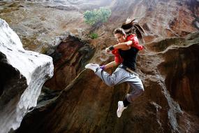 woman jumping in gorge