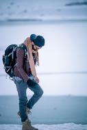 Stylish Boy walking with backpack in snowy winter, pakistan