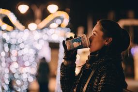 woman with hot drink in winter