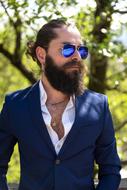 stylish adult man in blue sunglasses