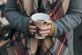 plastic cup with Coffee in female hands