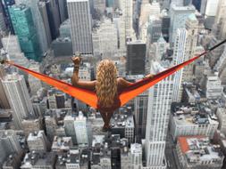 Woman laying in Hammock above New York city, digital art