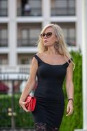 Blonde woman in sunglasses walking on the street